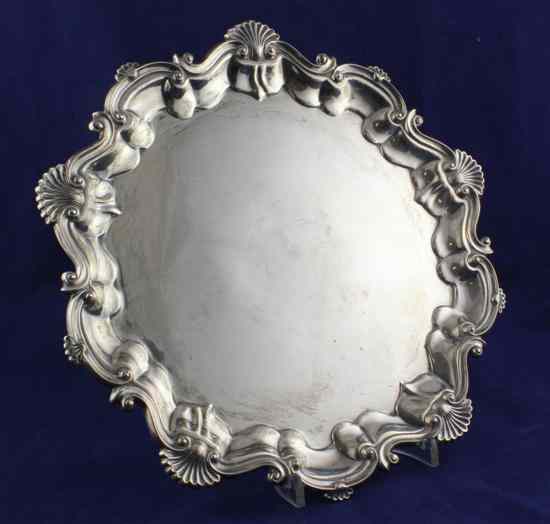 Appraisal: An Edwardian silver salver of shaped circular form with shell