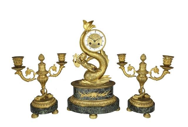 Appraisal: An ormolu clock set the drum shaped case with dolphin