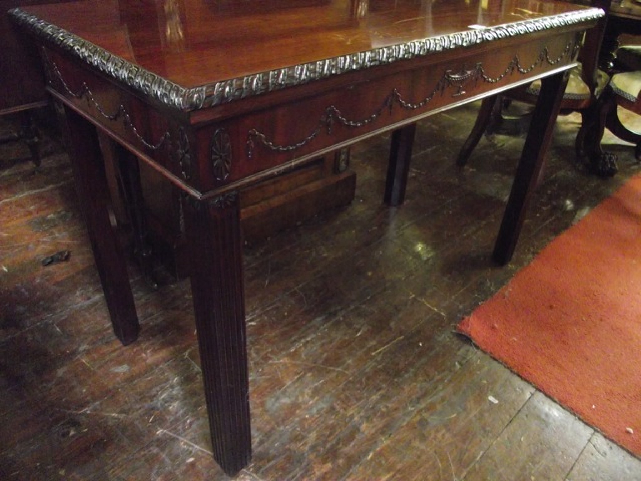 Appraisal: A th century mahogany serving table in the th century