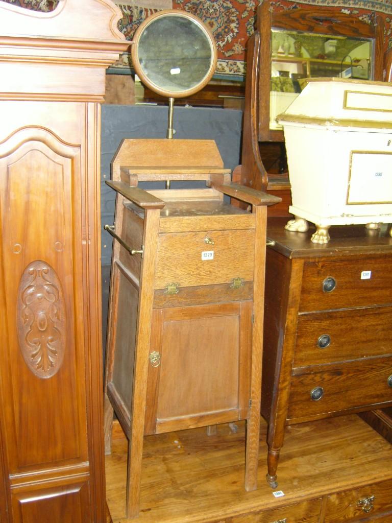 Appraisal: An Edwardian oak floor standing shaving stand of A-shaped tapered