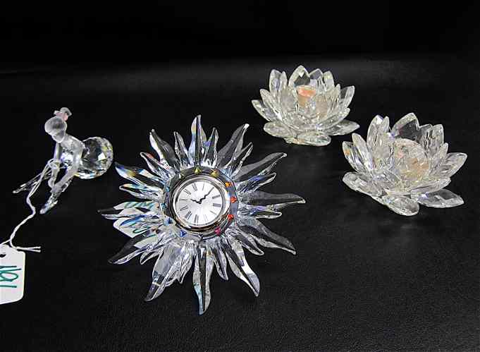 Appraisal: FOUR SWAROVSKI CRYSTALS Solaris Table Clock pair of Lotus Candlesticks