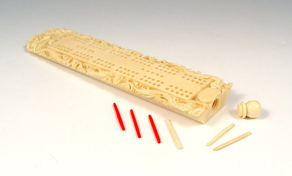 Appraisal: CHINESE CARVED IVORY CRIBBAGE BOARD Carved with dragon motif pegs