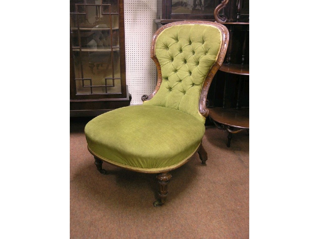 Appraisal: A Victorian walnut nursing chair upholstered in a buttoned green