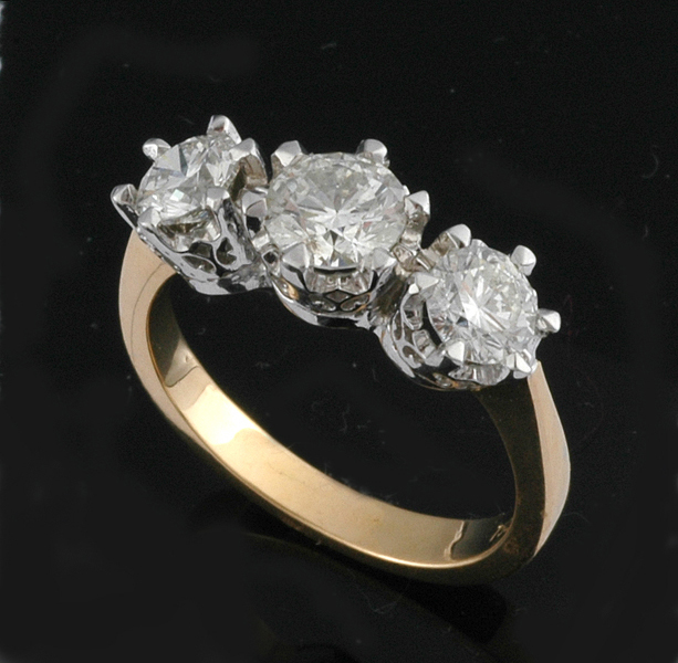 Appraisal: A DIAMOND THREE STONE RING Centrally set with a round