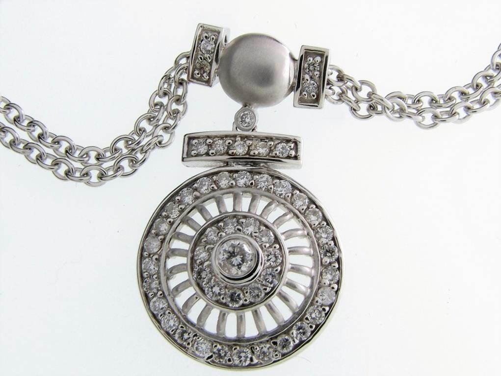 Appraisal: A K white gold double bail pendant featuring a diameter