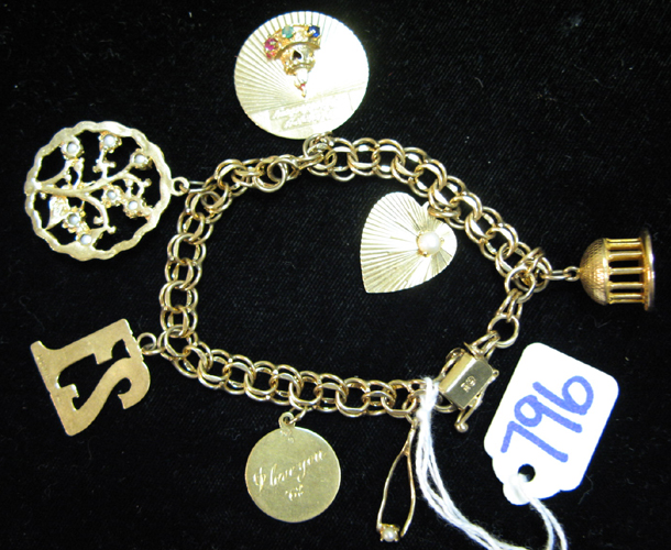 Appraisal: FOURTEEN KARAT GOLD CHARM BRACELET the - inch chain suspends