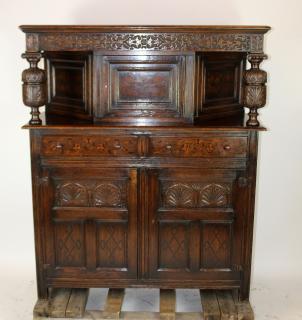 Appraisal: English Jacobean court cupboard in carved oak with barrel columns