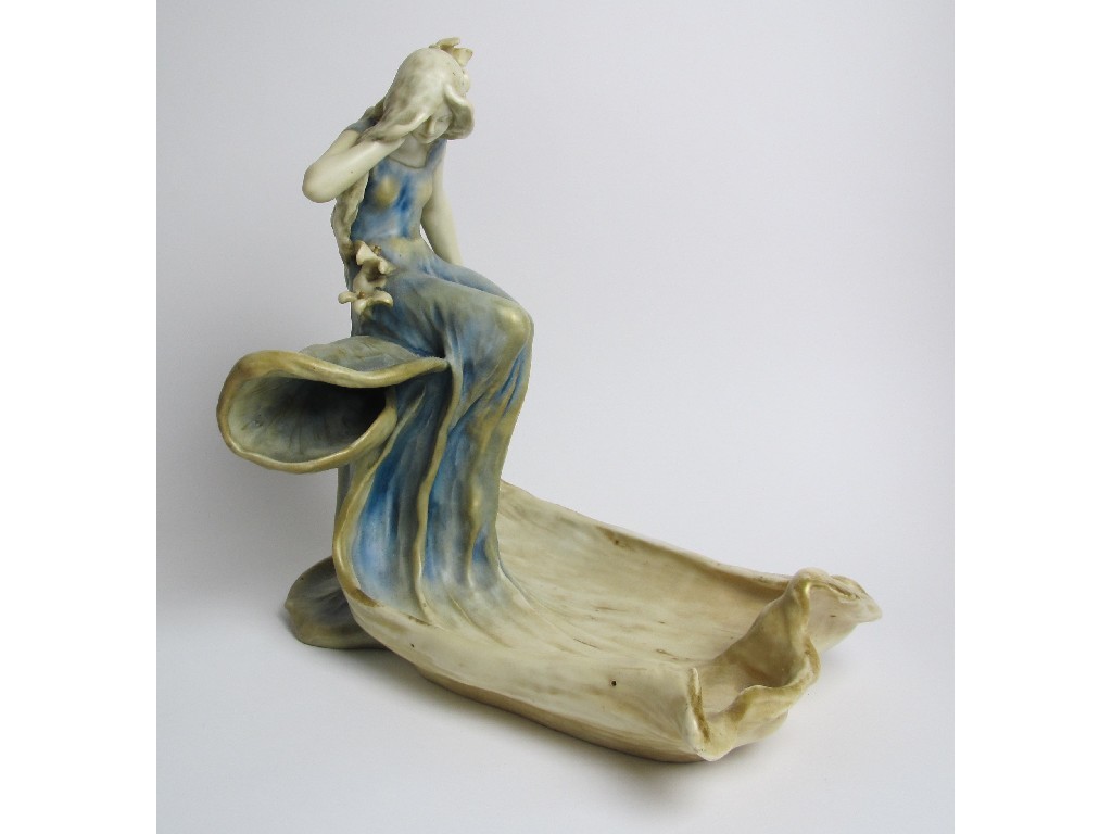 Appraisal: An Amphora porcelain centrepiece modelled with a maiden seated on