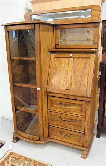 Appraisal: LATE VICTORIAN STYLE OAK SECRETARY CHINA CABINET ''Keepsakes'' line by