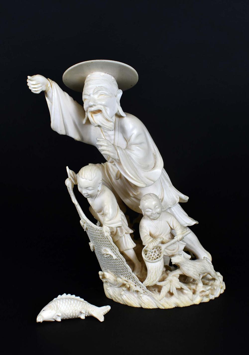 Appraisal: CHINESE CARVED FIGURE OF A FISHERMAN AND HIS SONSThe fisherman