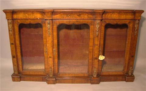 Appraisal: ENGLISH WALNUT VENEERED AND ORMOLU MOUNTED GLASS BOOKCASE the molded