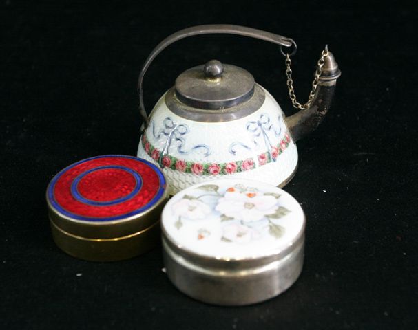 Appraisal: A miniature enamelled teapot together with two enamel compacts