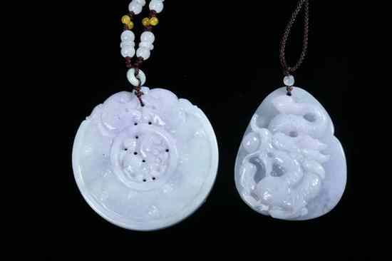 Appraisal: TWO CHINESE LAVENDER AND CELADON JADEITE PENDANTS One bi carved