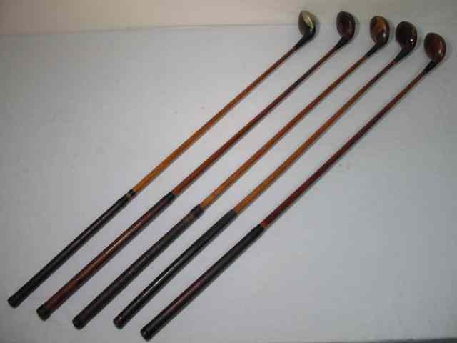 Appraisal: Fancy face wood shaft golf clubs total Includes a Burke