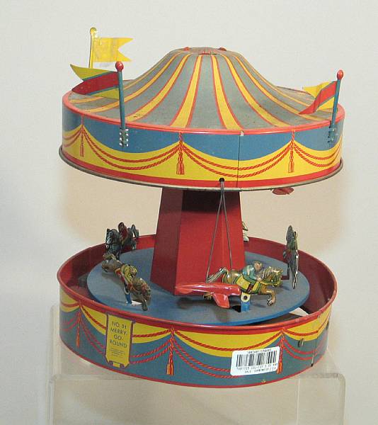 Appraisal: Wolverine Tin Lithographed toys American articulating merry-go-round with tin horses