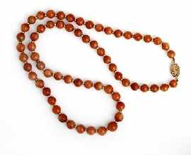 Appraisal: A mm diameter orange bead necklace with ct gold spacers