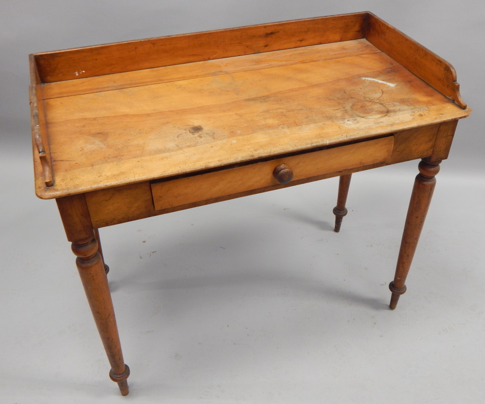 Appraisal: A Victorian satin birch washstand with a raised gallery above