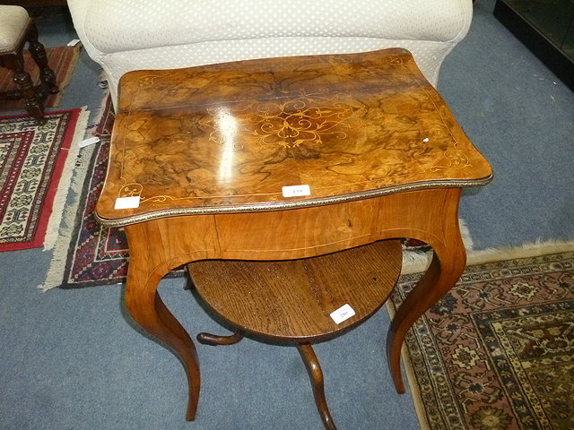 Appraisal: A TH CENTURY CONTINENTAL WALNUT SERPENTINE TOPPED TABLE with decorative