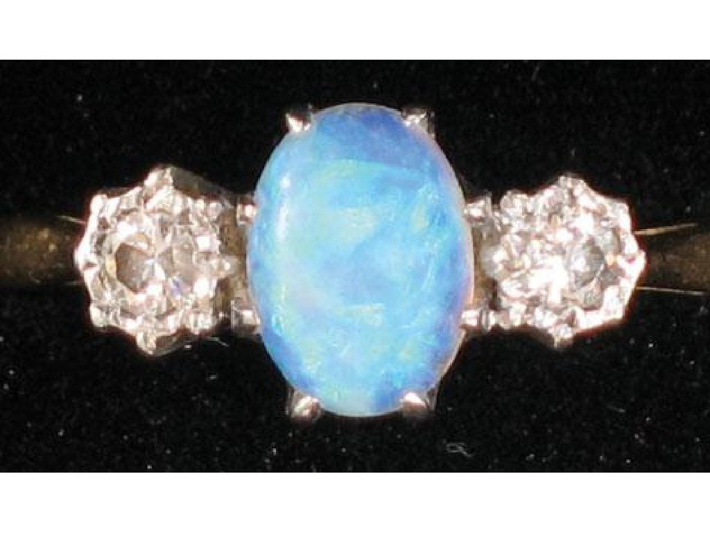 Appraisal: AN OPAL AND DIAMOND RING the central oval cabochon opal