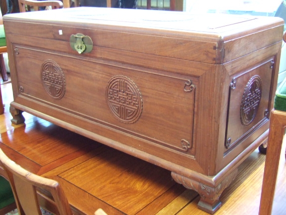 Appraisal: A th century Chinese hardwood coffer with carved decoration raised