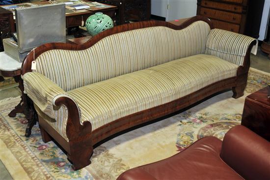 Appraisal: EMPIRE SOFA Mahogany veneered sofa with shaped back rolled arms