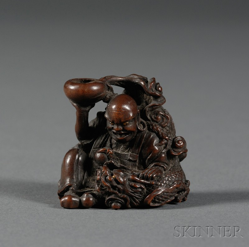 Appraisal: Hardwood Netsuke th century Rakan with a dragon emerging from