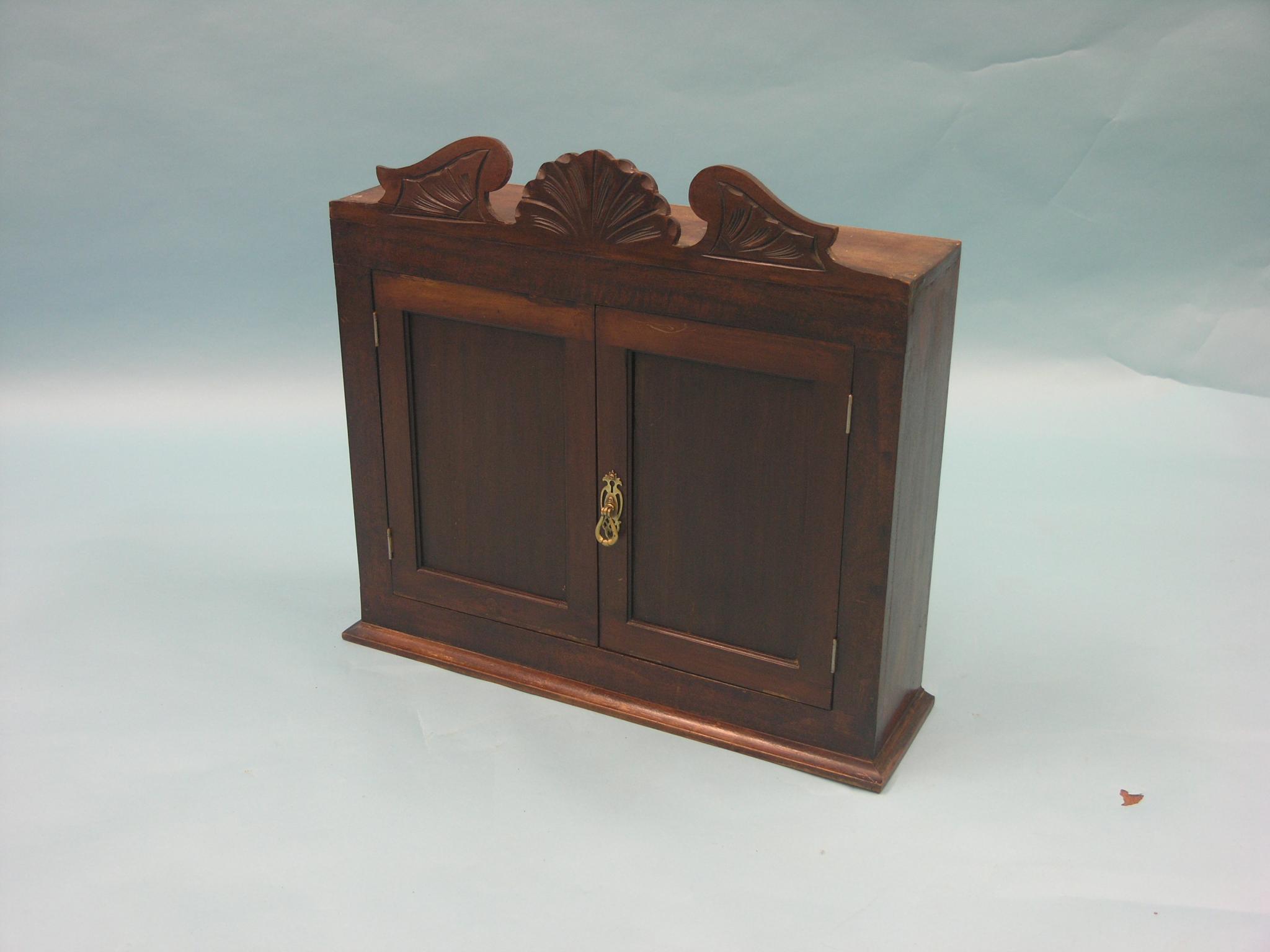 Appraisal: A Victorian mahogany spice cupboard break-arch pediment above pair of