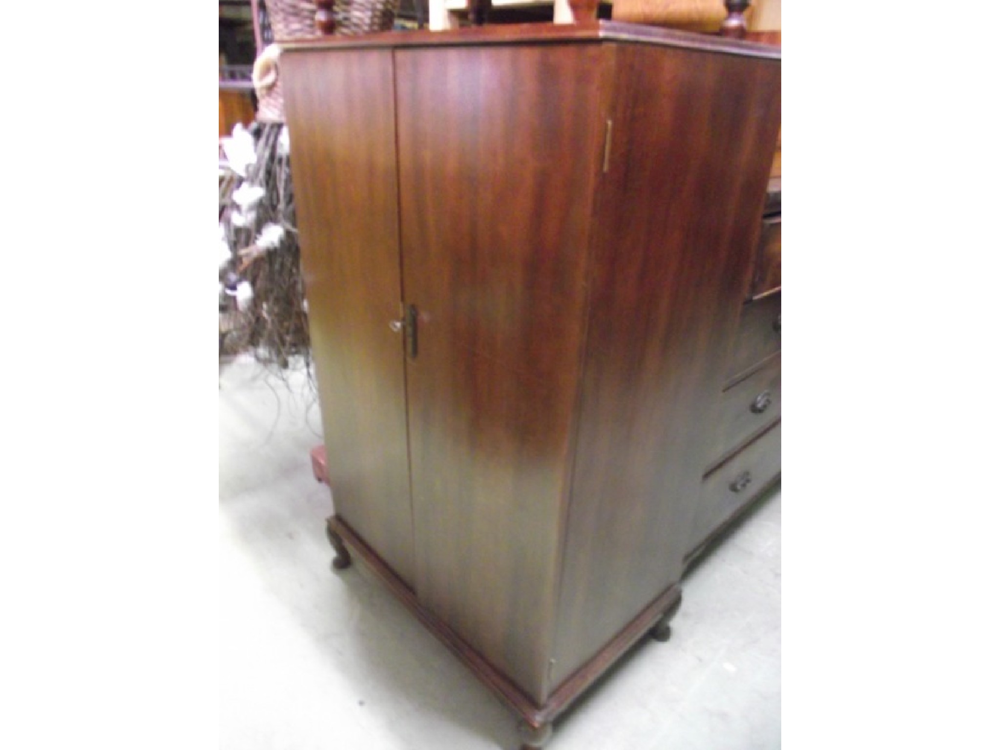 Appraisal: An early th century mahogany linen cupboard with crossbanded detail