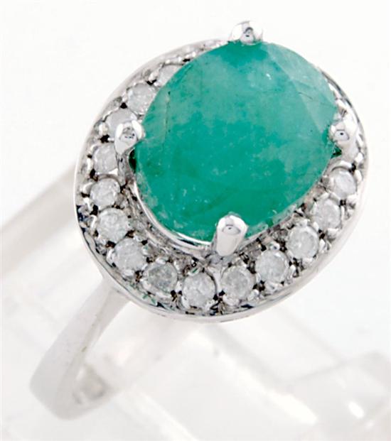 Appraisal: Emerald and diamond cocktail ring carat oval emerald surrounded by