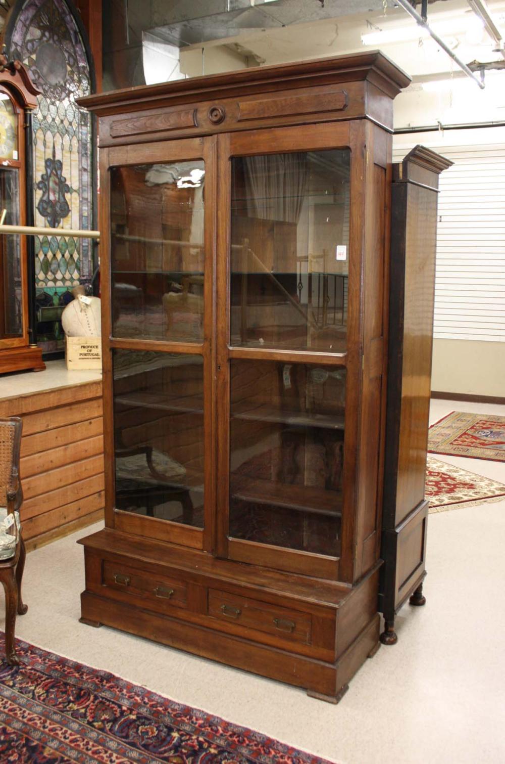 Appraisal: VICTORIAN WALNUT CABINET BOOKCASE ON CHEST American c the cabinet