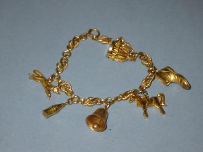 Appraisal: A CT GOLD CHARM BRACELET the fancy links hanging with