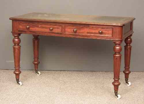 Appraisal: A Victorian mahogany writing table with oak top and rounded