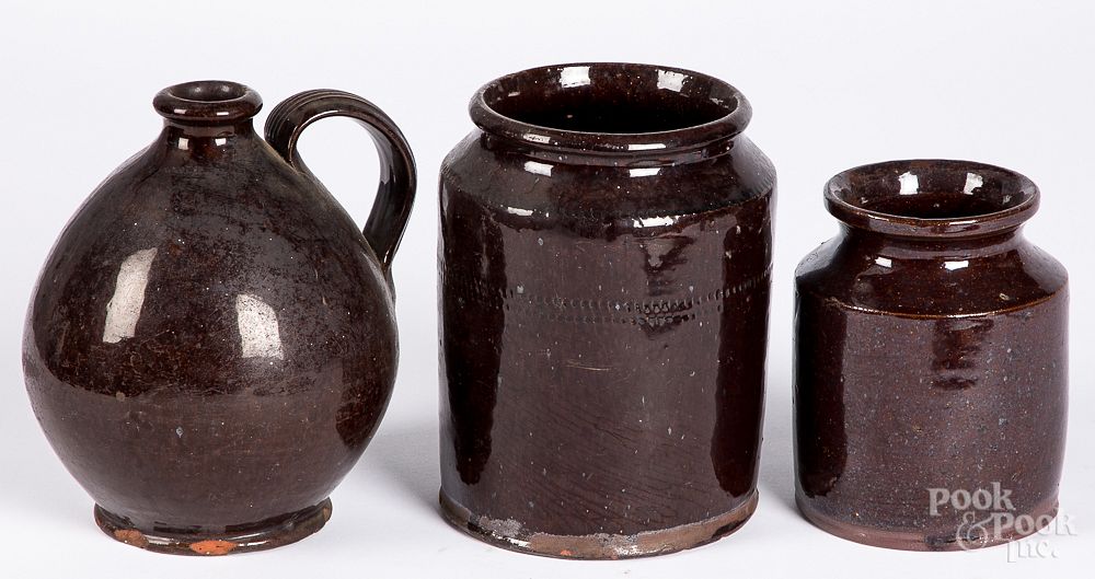 Appraisal: Two redware crocks and a jug th c Two redware