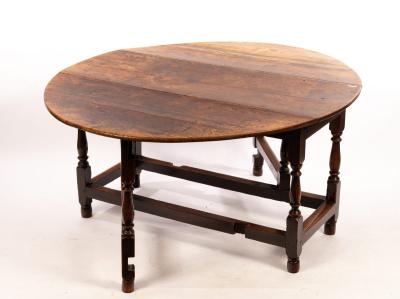 Appraisal: An oval oak gateleg table the two-flap top on baluster