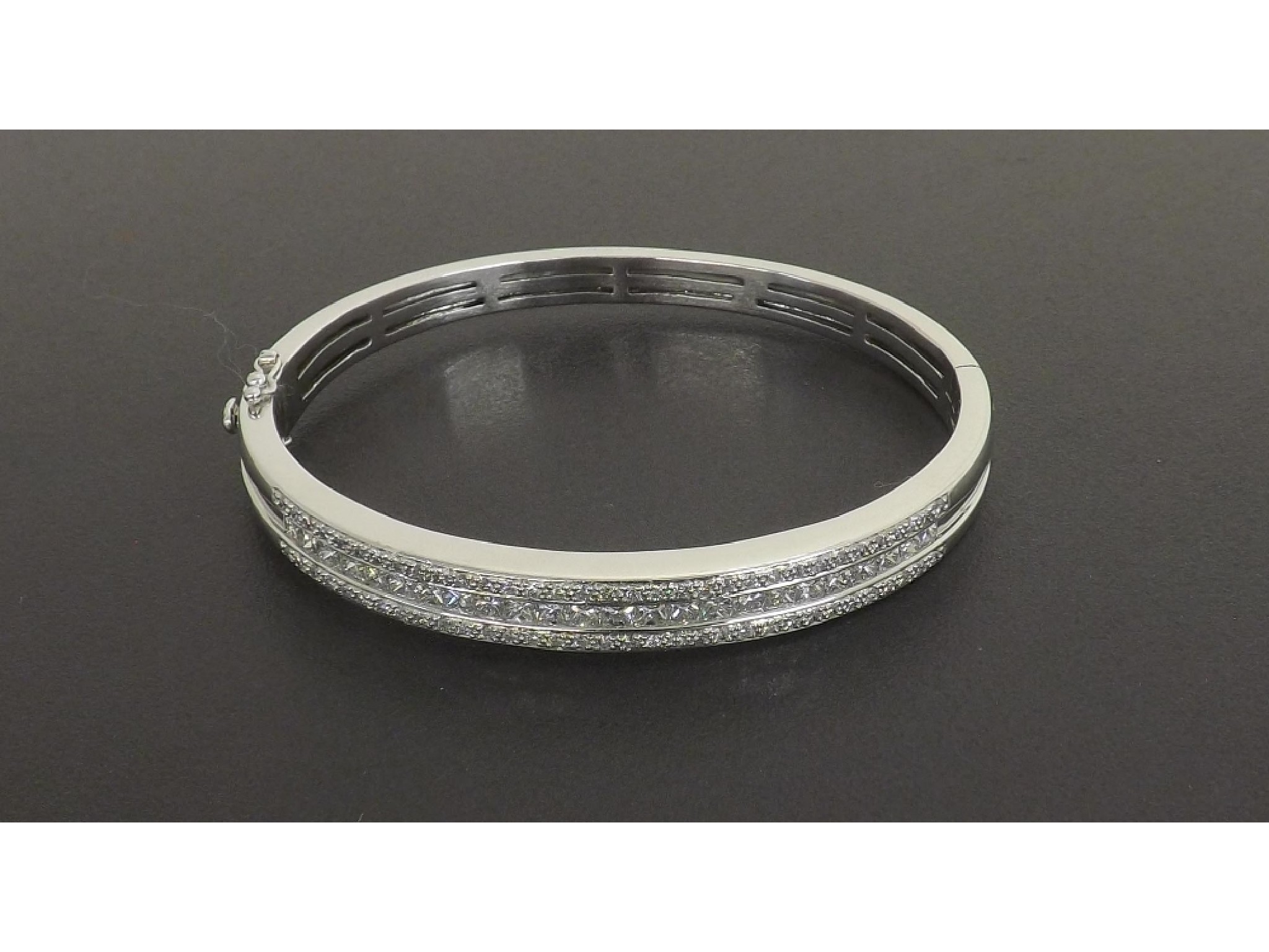 Appraisal: - -a ct white gold brilliant and princess-cut diamond hinged