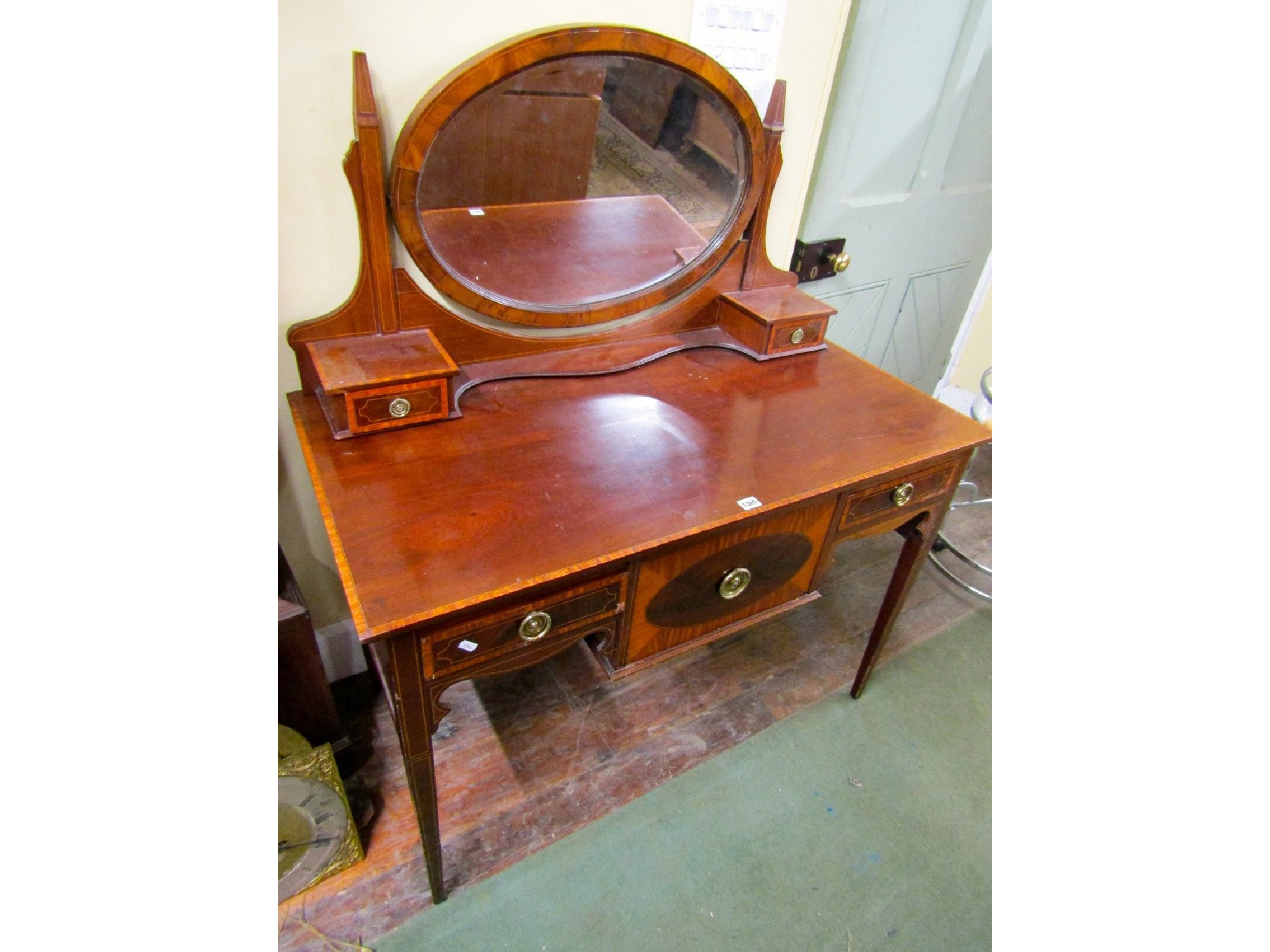 Appraisal: An inlaid Edwardian mahogany dressing table fitted with three frieze