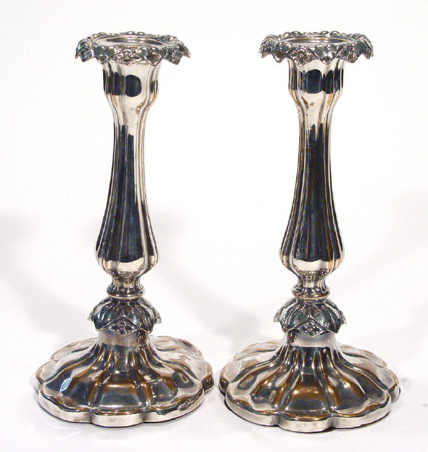 Appraisal: Pair of fluted silver plated candlesticks with floral mouldings cm