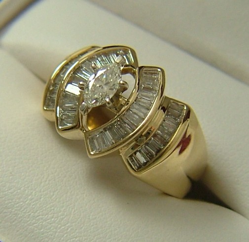 Appraisal: DIAMOND AND FOURTEEN KARAT GOLD RING channel set baguette diamonds