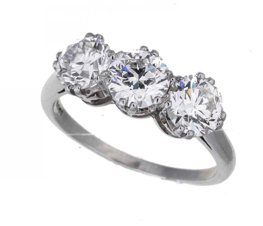 Appraisal: A DIAMOND THREE-STONE RING with round brilliant cut diamonds platinum