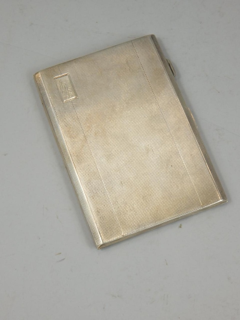 Appraisal: An engine turned Art Deco style silver cigarette case initialled