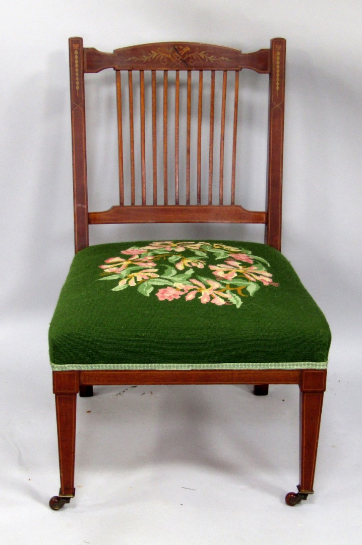 Appraisal: An Edwardian mahogany nursing chair the slatted back with painted