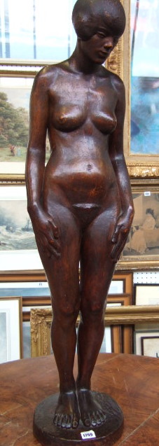 Appraisal: A Stinkwood carved sculpture of a female nude on integral