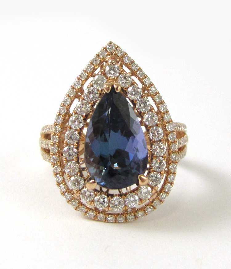 Appraisal: TANZANITE AND FOURTEEN KARAT ROSE GOLD RING with round-cut diamonds