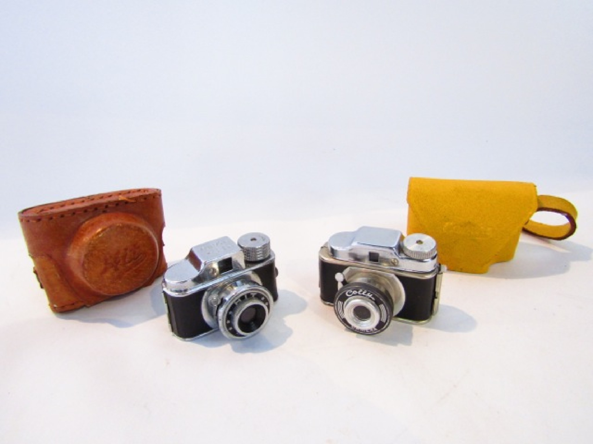 Appraisal: A miniature Colly camera in a yellow leather case together