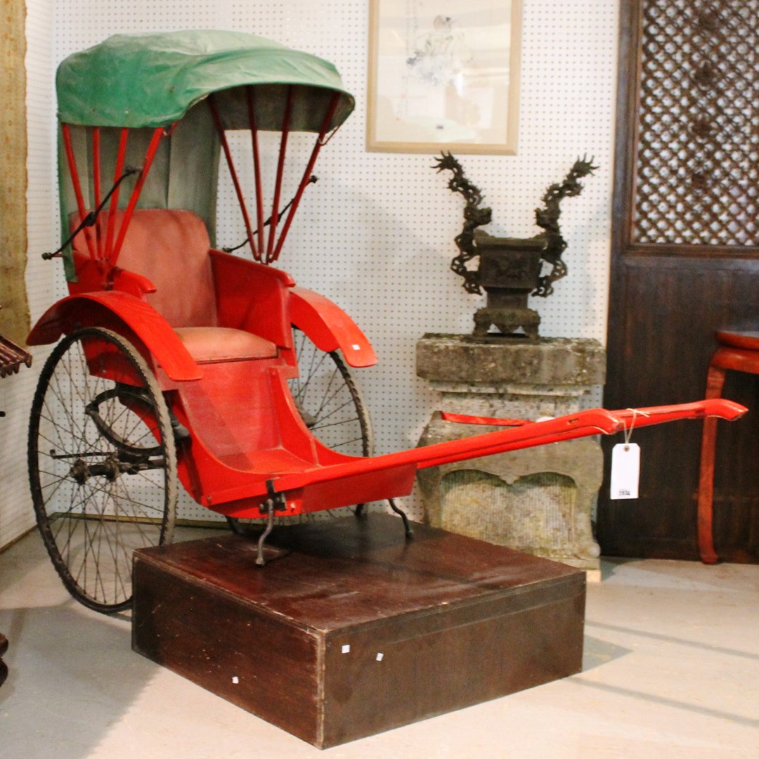 Appraisal: A th century red painted rickshaw with integral green hood