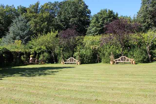 Appraisal: A PAIR OF LUTYENS STYLE TEAK GARDEN SEATS with camel