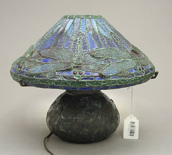 Appraisal: A Tiffany style patinated bronze and leaded glass dragonfly lamp