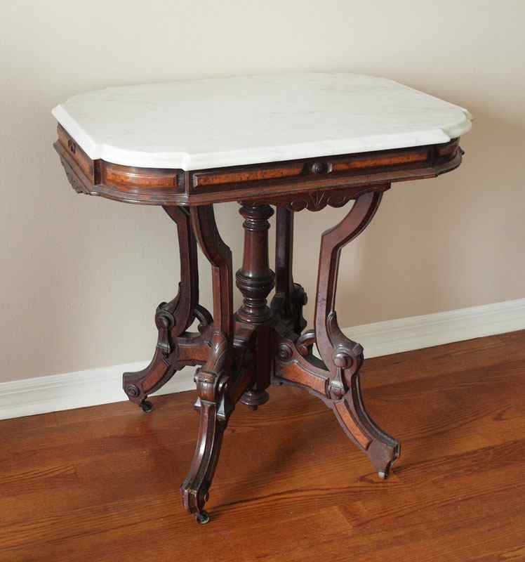 Appraisal: VICTORIAN WALNUT MARBLE TOP PARLOR TABLE Central turned pedestal and