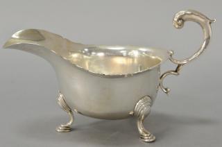 Appraisal: English silver gravy boat with scroll handle on three legs