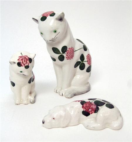 Appraisal: PLICHTA MEDIUM CAT FIGURE POST decorated with red clover printed